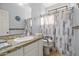 Bright bathroom features granite counters and a shower tub combo at 5291 W Angela Dr, Glendale, AZ 85308