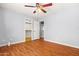 Comfortable bedroom featuring a ceiling fan, wood floors, and a walk-in closet at 5291 W Angela Dr, Glendale, AZ 85308