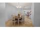 Bright dining room with a round wood table illuminated by a chandelier and tiled floor at 5291 W Angela Dr, Glendale, AZ 85308