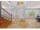 Grand entryway boasting high ceilings, tile flooring, staircase and natural light from multiple windows at 5291 W Angela Dr, Glendale, AZ 85308