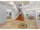 Spacious foyer with travertine floors, elegant staircase, adjacent dining area, and open layout at 5291 W Angela Dr, Glendale, AZ 85308