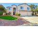 Stunning two-story home with a three-car garage, well-manicured lawn, and desert landscaping at 5291 W Angela Dr, Glendale, AZ 85308