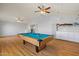 Game room featuring a pool table with mounted shelving and a view into another room at 5291 W Angela Dr, Glendale, AZ 85308