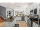 Bright kitchen view of an island, granite counters, and stainless steel appliances at 5291 W Angela Dr, Glendale, AZ 85308