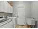 Bright laundry room features lots of storage and a utility sink at 5291 W Angela Dr, Glendale, AZ 85308