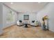 Light-filled living room with travertine tile, two sofas, stylish decor, and a tranquil ambiance at 5291 W Angela Dr, Glendale, AZ 85308