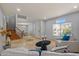 Inviting living room with travertine tile, staircase, and a sunlit ambiance through a window at 5291 W Angela Dr, Glendale, AZ 85308