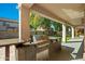 Outdoor kitchen featuring a built-in grill, countertop space, and sink for ultimate outdoor cooking experience at 5291 W Angela Dr, Glendale, AZ 85308