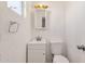 Cozy bathroom featuring a single sink vanity, a toilet, and neutral color palette at 5517 N 61St Ln, Glendale, AZ 85301