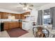 Traditional kitchen with wooden cabinets, tile flooring, and a cozy breakfast nook with views of the outdoors at 5517 N 61St Ln, Glendale, AZ 85301