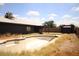 Backyard featuring an in-ground pool, shed, and patio area, with ample space for outdoor activities at 6319 E Albany St, Mesa, AZ 85205