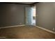 View of the bedroom with blue walls and a doorway at 6319 E Albany St, Mesa, AZ 85205