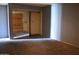 View of the bedroom with mirrored closet doors and gray walls at 6319 E Albany St, Mesa, AZ 85205