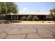 Charming single-story home featuring a well-maintained front yard and a freshly painted dark blue exterior at 6319 E Albany St, Mesa, AZ 85205
