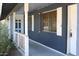 A cozy front porch with brick accent walls and view of the front yard at 6319 E Albany St, Mesa, AZ 85205