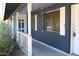 A cozy front porch with brick accent walls and view of the front yard at 6319 E Albany St, Mesa, AZ 85205