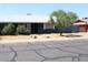 A well kept single story home featuring minimal desert landscaping and a white roof at 6319 E Albany St, Mesa, AZ 85205