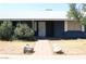 A blue single story home featuring minimal desert landscaping and a white roof at 6319 E Albany St, Mesa, AZ 85205