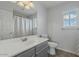 Bathroom features a vanity with decorative mirror and an enclosed tub and shower combo at 7650 E Williams Dr # 1038, Scottsdale, AZ 85255