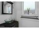 Modern bathroom features a glass bowl sink, decorative mirror and towel rack at 7650 E Williams Dr # 1038, Scottsdale, AZ 85255