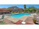 Community pool with lounge seating and well-maintained landscaping, ideal for outdoor relaxation at 7650 E Williams Dr # 1038, Scottsdale, AZ 85255