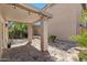 Covered outdoor patio area features a stone floor, landscaping and overhead lighting at 7650 E Williams Dr # 1038, Scottsdale, AZ 85255