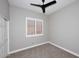 Carpeted bedroom with gray walls, ceiling fan, white trim, and window with shutters at 7741 E Journey Ln, Scottsdale, AZ 85255