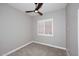 Bedroom with a ceiling fan, carpeted floor, and window with white shutters at 7741 E Journey Ln, Scottsdale, AZ 85255