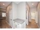 Hallway with built-in cabinetry, wood flooring, recessed lighting, and white doors at 7741 E Journey Ln, Scottsdale, AZ 85255