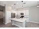 Well-lit kitchen with white cabinets, quartz countertops, and stainless steel appliances at 7741 E Journey Ln, Scottsdale, AZ 85255