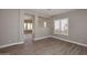 Open living room with wood-look tile floors and neutral walls at 7741 E Journey Ln, Scottsdale, AZ 85255