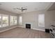 Bright living room with a ceiling fan and fireplace at 7741 E Journey Ln, Scottsdale, AZ 85255