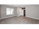 Neutral living room with wood-look tile flooring and bright windows at 7741 E Journey Ln, Scottsdale, AZ 85255