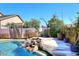 Backyard pool featuring a rock waterfall feature and ample patio space at 7741 E Journey Ln, Scottsdale, AZ 85255