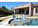 Inviting backyard pool with submerged lounge chairs and covered patio area at 7741 E Journey Ln, Scottsdale, AZ 85255