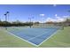 Community tennis courts with blue playing surface and lighting at 7741 E Journey Ln, Scottsdale, AZ 85255