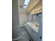 Modern bathroom featuring double vanity, granite countertop, and skylight at 8427 W Glendale Ave # 31, Glendale, AZ 85305