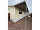 Home exterior featuring yellow siding, a carport, and low-maintenance landscaping at 8427 W Glendale Ave # 31, Glendale, AZ 85305