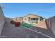 Expansive backyard with vibrant bougainvillea, fountain, seating, and well manicured landscaping at 8490 S 165Th Dr, Goodyear, AZ 85338