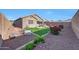 Sprawling backyard featuring a green lawn, an outdoor kitchen, and an inviting outdoor seating area at 8490 S 165Th Dr, Goodyear, AZ 85338