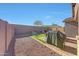 Well-maintained backyard featuring a grill, patio area, seating and mature landscaping at 8490 S 165Th Dr, Goodyear, AZ 85338