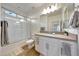 Bright bathroom featuring a walk-in shower with tile surround, vanity, and sink with modern fixtures at 8490 S 165Th Dr, Goodyear, AZ 85338