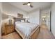 Inviting bedroom showcasing a comfortable bed, ceiling fan, and an access doorway, offering tranquility at 8490 S 165Th Dr, Goodyear, AZ 85338