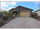 Charming single-story home featuring a brick driveway, desert landscaping, and a two-car garage at 8490 S 165Th Dr, Goodyear, AZ 85338