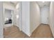 Hallway with wood-look tile flooring and white walls at 8490 S 165Th Dr, Goodyear, AZ 85338