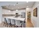 Modern kitchen with white cabinets, quartz countertops, stainless steel appliances, and island with seating at 8490 S 165Th Dr, Goodyear, AZ 85338