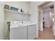 Efficient laundry room featuring modern washer and dryer units, with ample storage space and an access doorway at 8490 S 165Th Dr, Goodyear, AZ 85338