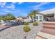 Backyard oasis featuring a patio, desert landscaping, and steps to a fire pit area at 877 E La Costa Pl, Chandler, AZ 85249