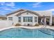 Backyard pool with lush landscaping and desert plants surrounded by a patio at 877 E La Costa Pl, Chandler, AZ 85249