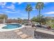 Beautiful backyard featuring a pool, desert landscaping, and stunning waterfront views at 877 E La Costa Pl, Chandler, AZ 85249